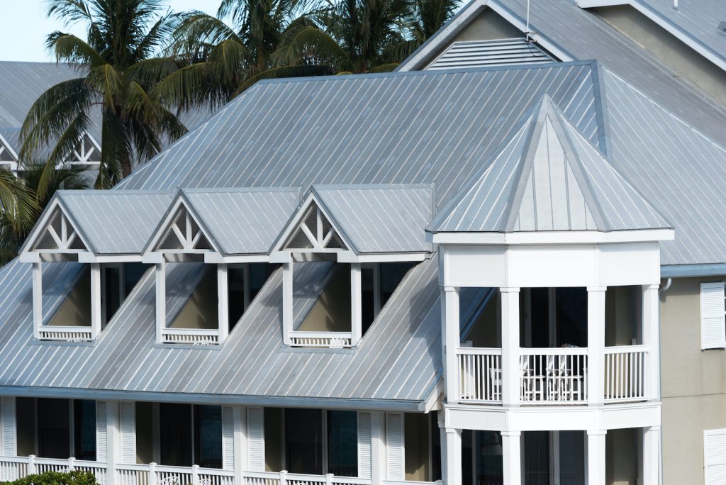 Modern house with a silver metal roof and dormer windows.